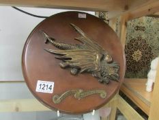 A bronze dragon with Latin motto 'Furicus Et Furiosus' mounted on a bakelite board.