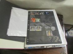 3 albums/stock books and loose sheet of Queen Elizabeth II British stamps.
