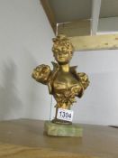 A heavy cast metal bust of a lady.