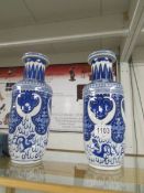 A pair of late 19th century blue and white Chinese vases with four character marks to underside