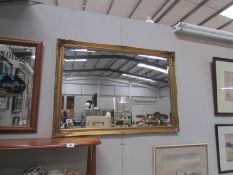 A gilt framed mirror.