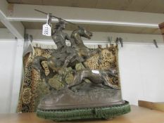 A 19th century figure of a horse with rider slaying a lion.