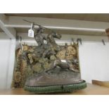 A 19th century figure of a horse with rider slaying a lion.