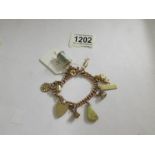 A gold charm bracelet with charms, approximately 38 grams.