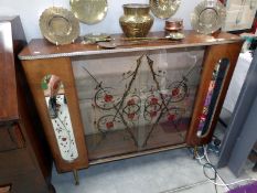 A vintage glass display cabinet