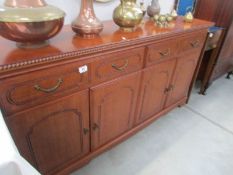 A modern mahogany effect sideboard.