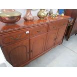 A modern mahogany effect sideboard.