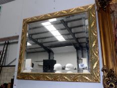 An ornate bevel edged mirror