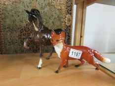 A large Beswick fox and a Beswick horse with raised leg.