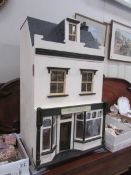 A 3 storey dolls house complete with furniture.