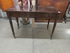 A 3 drawer mahogany side table.