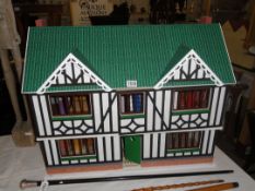 A kit built dolls house with furniture.