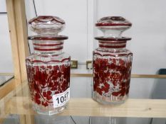 A pair of ruby flashed cut glass pickle jars.