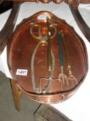 3 brass toasting forks, a pair of brass coal tongs all on a copper tray.
