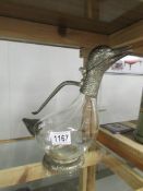 A glass claret jug with silver plated duck spout.