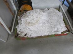 A box of linen and lace items.