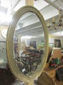 A Victorian oval mirror.