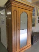 A Victorian mahogany wardrobe with mirror door and drawer.