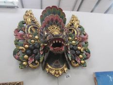 A wall hanging of the bird diety Garuda.