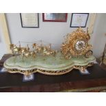 A large fabulous gilded brass coach and horses clock with quartz movement,.