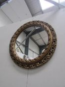 A circular gilt framed mirror.