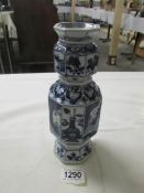 A circa 17th century blue and white vase with depictions of characters and objects,