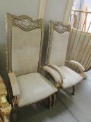A pair of silver and gold painted ormolu hall chairs with leather upholstery.