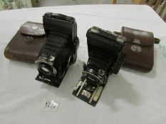 A Vuigllander folding camera in leather case and an N Sign Prontor II folding camera in leather