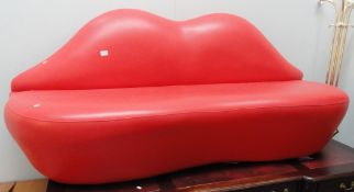 A red lips sofa in the style of the Bocca sofa based on the lips of Marilyn Monroe.