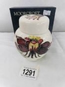 A boxed Moorcroft ginger jar 'Columbine Aguilegia' pattern.