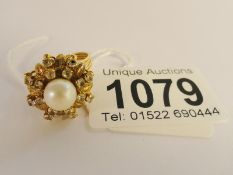 A circa 1970's 14ct gold cluster ring set with centre cultured pearl in a basket setting,