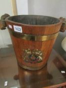 An old oak fire bucket with crest.