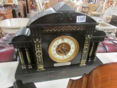 A black slate mantel clock with silver dedication, both springs ok but wound to limit. (no key).