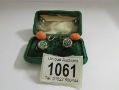 A pair of vintage turquoise set clip earrings and a pair of silver set pendant earrings.