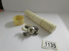 A 19th century silver rattle, a napkin ring and a shaving box.