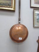 A copper warming pan.