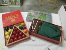 An early Subbuteo table soccer set with card figures and a set of Durolite snooker balls.