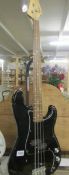 A Fender Squier bass guitar, 20th anniversary model.