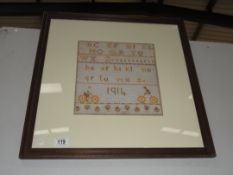 A framed and glazed sampler (Alphabet and dated 1914).