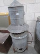 A galvanised gas boiler with cylindrical chimney/top.