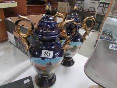 A pair of continental pottery lidded vases.