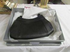 A boxed black Salvatore Ferragano hand bag,.