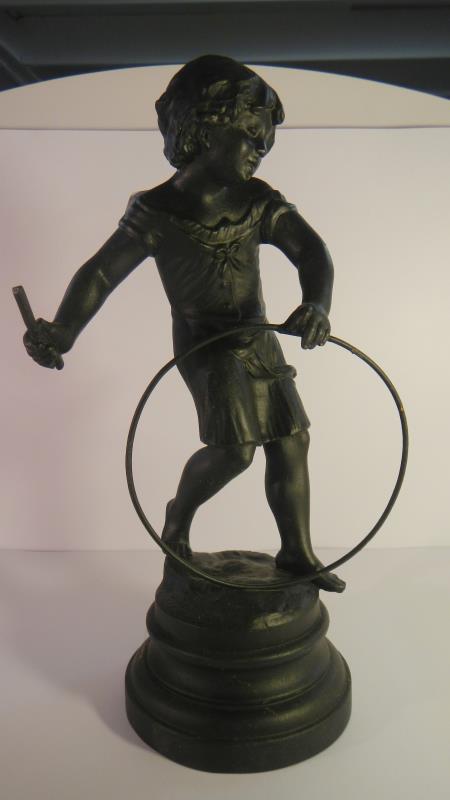 A spelter figure of a boy playing with a hoop together with a posing nude lady figure. - Image 3 of 3