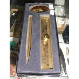 A boxed gold coloured Benson & Hedges pen and ruler set.