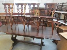 An oak refectory table and 4 chairs.