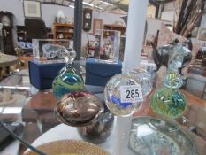 A collection of paperweights including signed Mdina examples.