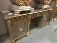 A gilded double pedestal sideboard.