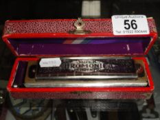 A boxed vintage Hohner Super Chromonica Chromatic harmonica.