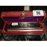 A boxed vintage Hohner Super Chromonica Chromatic harmonica.