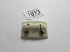 A pair of gold sapphire peardrop earrings, (missing 3 stones).